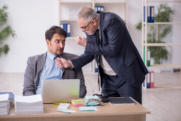 Two male employees in bullying concept