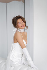a young bride in the style of France in a white dress in a figure and white gloves, with her eyes closed, on her neck a choker in the form of a white ribbon with a bow