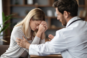 Therapist Man Comforting Upset Female Patient During Meeting In Clinic