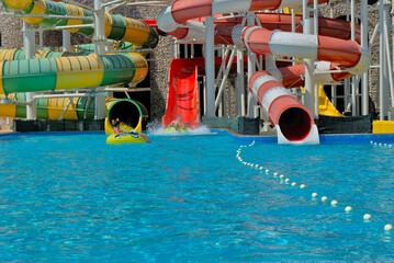 Water park for adults and children with water slides and pools for entertainment and outdoor activities.