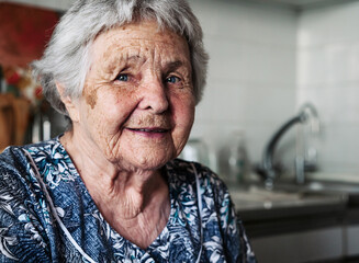 Portrait ninety two year old white caucasian senior woman at home looking at camera and smiling.