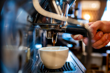 Fototapeta na wymiar Barista hand making cappuccino Coffee with espresso machine in cafe