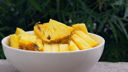 Juicy sliced pineapple is ready to eat, consumption of pineapple helps in weight loss and slimming of person. Tropical fruits of ripe pineapple rich in vitamins and minerals. Diet fruits fat burning.