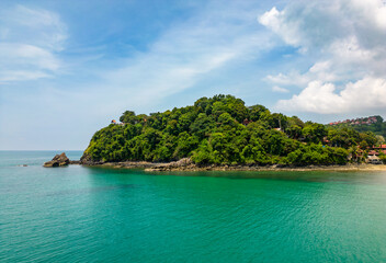 Aerial drone view of bamboo bay and beach at Koh Lanta island, Thailand. Tropical forest near the rocky beach and white sand with turquoise water.