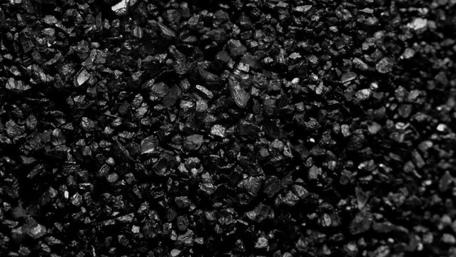 Black sand moving. Close-up of a black sand surface moving.