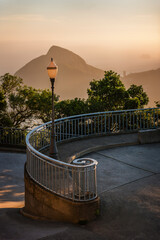Old street lamp in Rio de Janeiro, on Morro do Cristo Redentor, with a spiral curved iron handrail,...