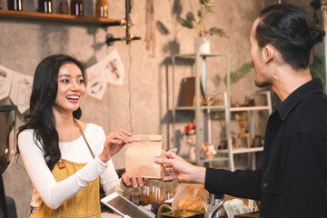 Happy business woman making coffee drinks and  serving bakery to customers at coffee shop by cheerful service.