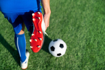 football soccer player stretching during warm up before kick ball in match league in stadium with...