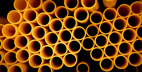 Background of the orange plastic pipes in stacked
