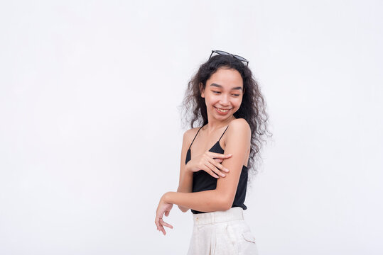 A young woman touching her soft flawless and supple skin on her arm, possible skin-care concept. Isolated on a white background.