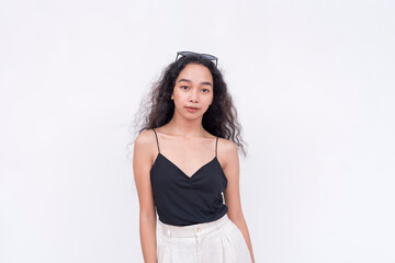 A slim and confident Filipino woman with long curly hair in her early 20s. Wearing a black...