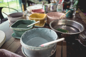 Jars with acrylic paints at a workshop