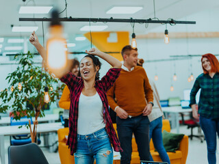 Obraz premium Group of business people throwing paper in air at modern startup office, team success and job done concept