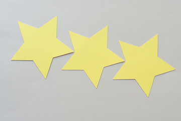 three yellow paper stars