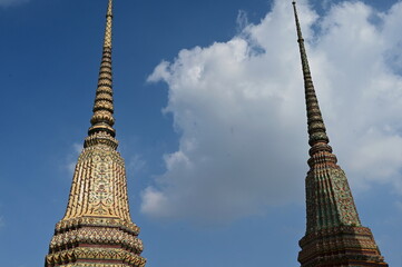 2 The top of a beautiful pagoda against the blue sky at Wat Pho or Wat Phra Chetuphon Reclining...