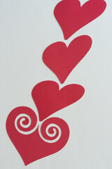 red paper hearts on blank paper