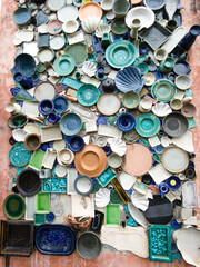 Different colorful ceramic plates on the orange wall