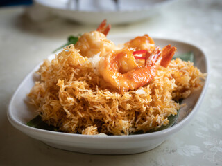 Delicious Mee Krob. Shrimp, crispy Thai rice noodles and sweet and sour sauce on white background and clipping paths. Selective focus.