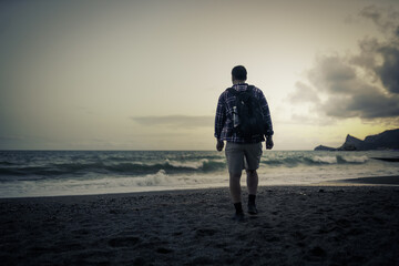 one men walking on the beach 
