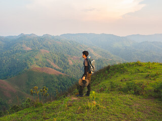 Men backpacker are happy and enjoy with sunrise after successful hiking.