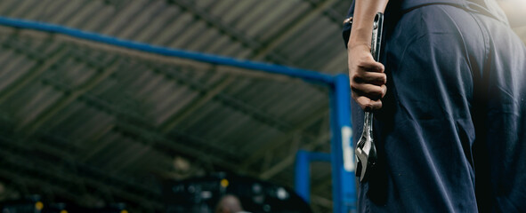 Panorama banner background. African american female holding tools with wrench. Car maintenance and auto service garage concept. Closeup hand and spanner.