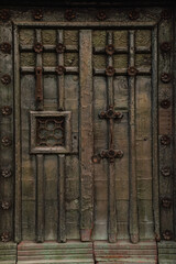 Old Italian green doors made of wood and metal