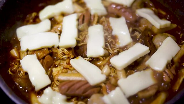 toppoki and noodles with cheese sausages