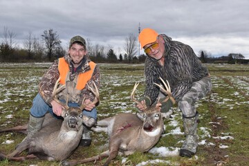 A pair of hunters with two trophy bucks