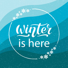 Winter is here. Vector hand lettering. white letters with snowflakes i a circle on gradient colors from iced blue to dark blue textured background. Winter holiday card. Banner poster flyer. Christmas.