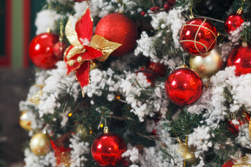 Christmas, New Year interior with gold and red balls and fur-tree decoration with snow. Selective focus
