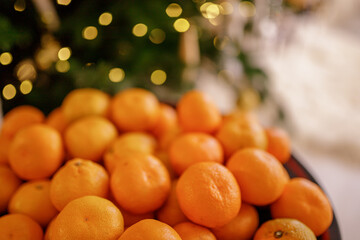 Christmas composition on colorful bokeh background. Mandarins against a background of blurry...