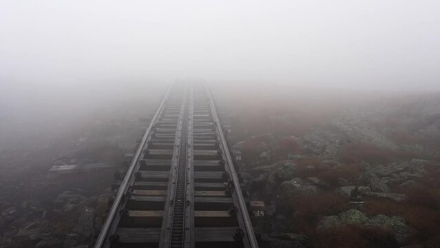 Journey through fog up Mount Washington on the world's first biodiesel cogwheel railroad in the White Mountains of northern New Hampshire, USA.