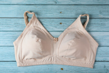 Woman's skin color Bra Isolated on wooden table
