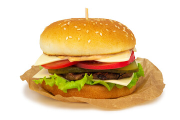 Hamburger with beef patty, tomatoes and cheese, placed on a piece of wrapping paper