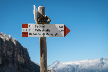 hiking trails wooden signs in Mountains . Brenta Group, Adamello Brenta Park - Madonna di Campiglio - Trentino Alto Adige - northern Italy, august 23, 2022