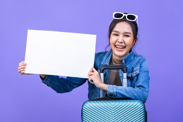 Excited young asian female tourist holding credit card , ready to flight, copyspace on violet colour background.