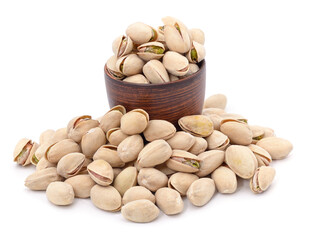 Bunch of pistachios in shell and cup.