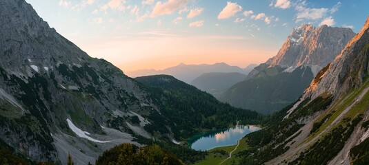Beautiful scenery of rocky mountainous landscape at sunset surrounding a small lake - Powered by Adobe