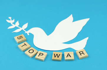 Peace symbol - dove and the word Stop War on a blue background