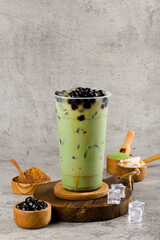 Boba or tapioca pearls is taiwan bubble milk tea in plastic cup with matcha flavor on texture ...