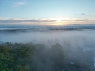 Aerial shot of clouds over the countryside at sunset