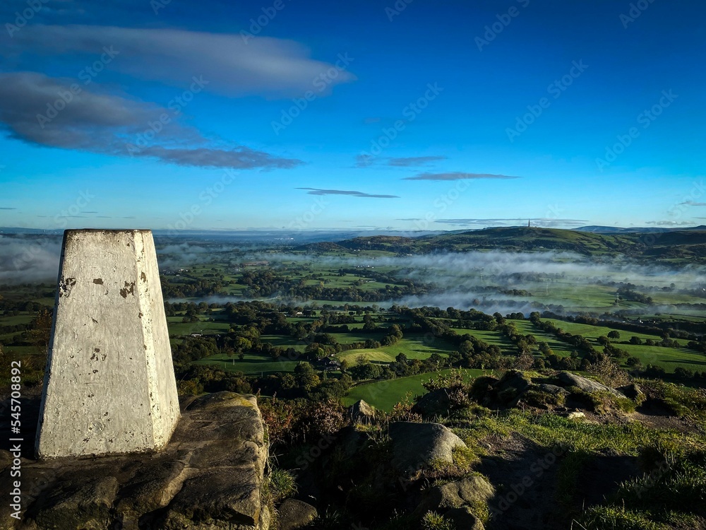Poster aerial view of stone in background of greenery field with dense trees in pendle hill