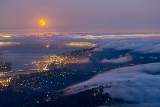 Aerial view of a foggy night with Super Moon in San Francisco Bay Area