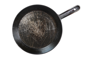 Flat lay of black cast-iron frying pan isolated on transparent background