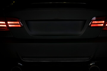 Fototapeta na wymiar Sport tuned car rear view in the dark