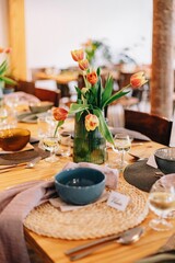Vertical shot of a decorated wedding table with tulip flowers