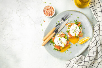 healthy breakfast with poached eggs, salmon and guacamole on toast. place for text, top view