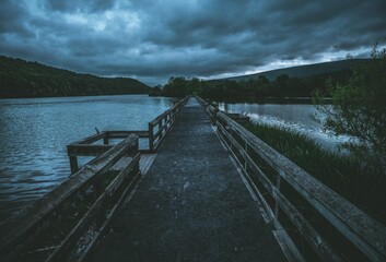 Fototapeta premium Empty bridge against the background of the cloudy sky.