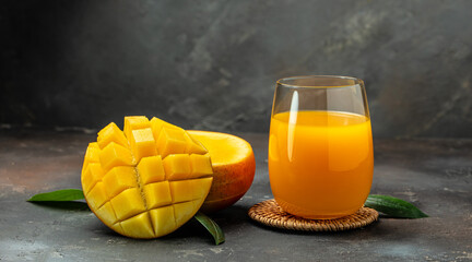 mango juice. Fresh tropical fruit smoothie on a dark background. Long banner format