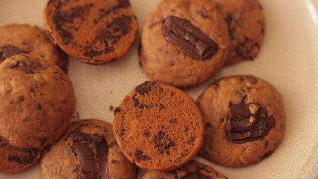 Top shot of cookies on a plate with more falling from abov